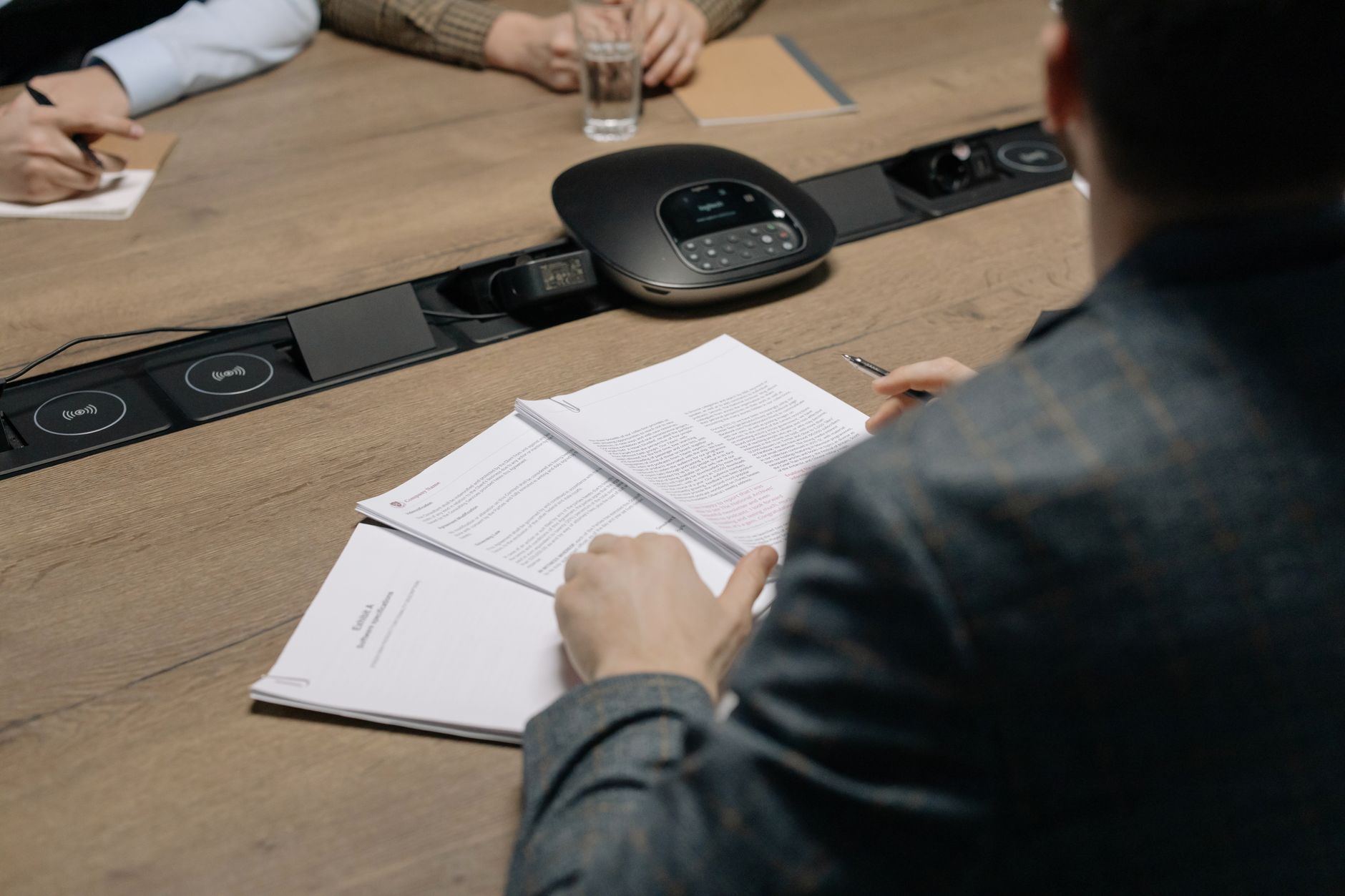 Person reviewing papers at a table